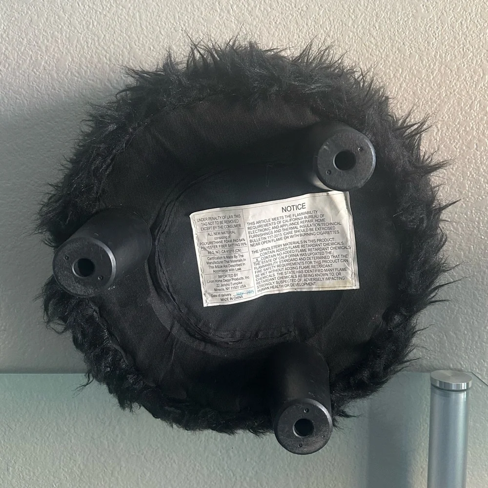 black faux fur ottoman/stool with 3 wooden legs